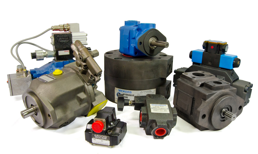 Remanufactured hydraulic piston pumps and vane pumps & motors, servo and proportional valves laid out on white background.